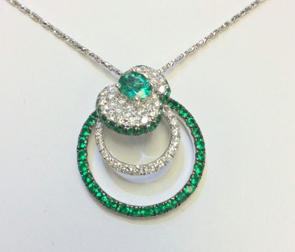 Emeralds and diamonds together in a white gold pendant 