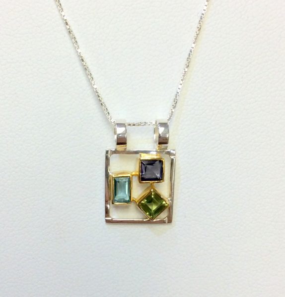 Gemstone pendant featuring iolite, peridot, and amethyst in a sterling silver setting
