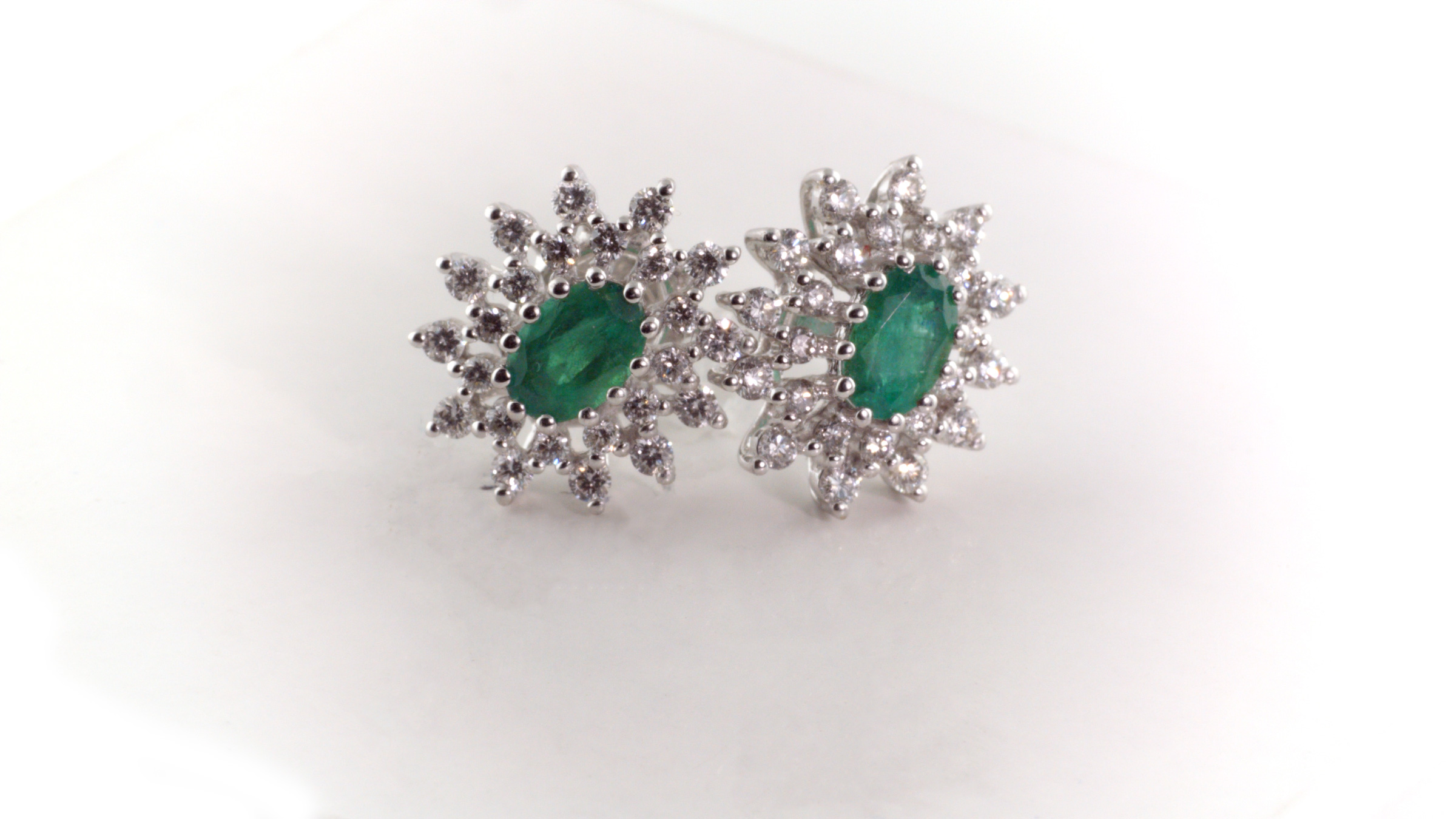 Emerald and diamond earrings in 14K white gold.