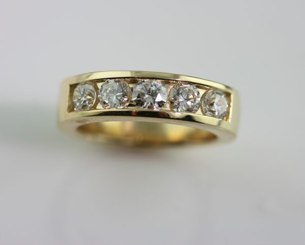 Custom men's wedding band in yellow gold with diamonds